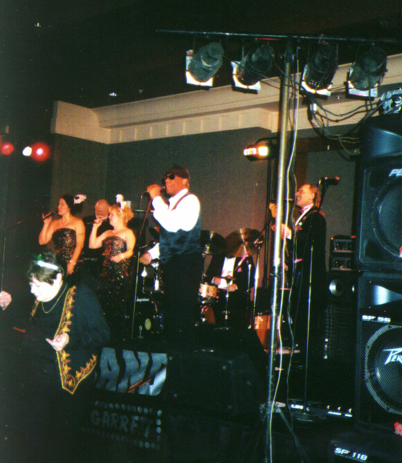 Lee Garret in white, the Boomettes on the left and Tomcat on the right.